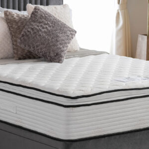 Apley Bale 1000 Encapsulated Pillowtop Mattress with plush pillowtop finish and edge-to-edge support, displayed in a bedroom with stylish, textured pillows.