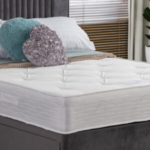 Apley Rupert Mattress with a soft damask fabric finish, displayed on a bed with decorative pillows in a modern bedroom setting.