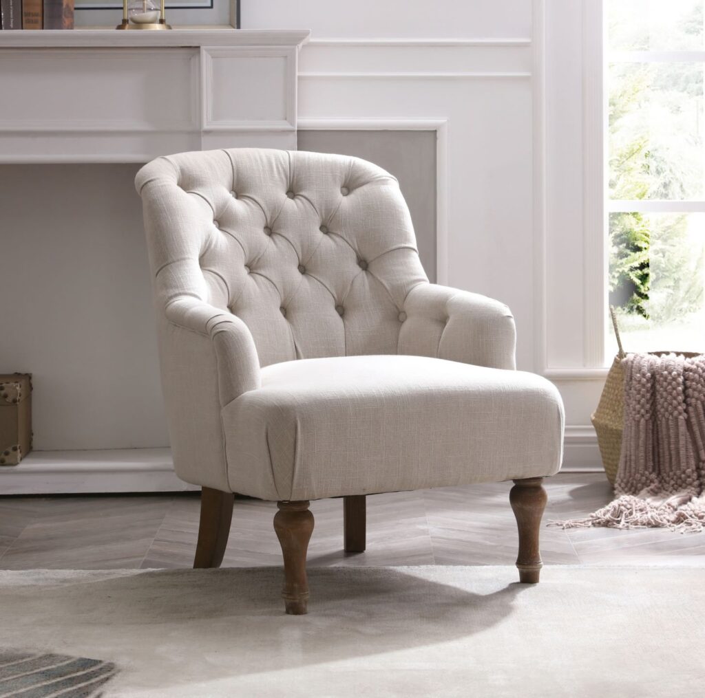 Cream Apley Bianca chair with a tufted backrest and wooden legs.