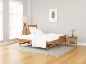This image shows a single bed frame made of solid oak from Apley Beds. The bed has a simple design with a straight headboard and footboard. The bed is finished in a natural oak stain. The image also shows a nightstand next to the bed. The nightstand is made of the same solid oak as the bed frame. The nightstand has a drawer and a shelf. The bed is available in a variety of sizes and finishes. The Eden guest bed is a versatile and stylish piece of furniture that would be perfect for any bedroom.