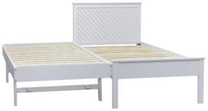 This image shows a chevron guest bed made from sustainable wood in the UK by Kyoto. The bed has a painted finish and a chevron headboard and footboard. The bed is also equipped with a trundle bed. The image is set against a white background.