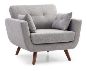 Kyoto Oslo Grey Fabric Armchair in a bright living room setting, showcasing its sleek Scandinavian design with contoured arms and wood tone legs, accompanied by a dark wooden side table, a plush grey cushion, and a lush potted palm plant, reflecting the award-winning contemporary furniture style available at Apley Beds UK.