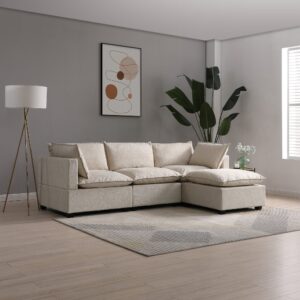 A contemporary Kyoto Moda corner sofa with a chaise, upholstered in natural bouclé fabric, offering a textured and inviting look. This elegant sofa is set in a modern room with grey walls, complemented by a stylish abstract wall art in earthy tones. To the left stands a tripod floor lamp with a white shade, and to the right, a large tropical plant in a simple pot adds a touch of greenery. A small side table with a vase of white flowers rests beside the sofa, all above a striped area rug, creating a harmonious and sophisticated living space.