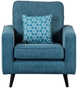 A Wentworth chair upholstered in Aegean blue fabric with a sturdy, clean-lined frame, featuring a comfortable seat cushion, flanked by armrests, and supported by black tapered legs. A patterned cushion in complementary blue shades rests against the chair's backrest, set in a room with a subtle grey stone feature wall, creating a serene and stylish seating area.