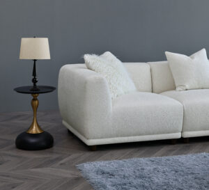 Side view of the Aluxo Lottie Modular Corner Sofa, with accent pillows and a side table