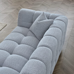 Top-down view of the Tribeca Corner Sofa in pearl bouclé fabric, decorated with matching cushions
