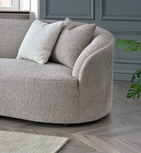 Close-up view of the Nolita sofa corner in Koala & Latte Bouclé with plush cushions and textured fabric.