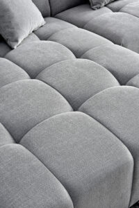 Detailed texture of Leonard sofa's tufted cushions in cloudy grey bouclé.