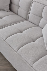 Close-up of the button detailing on the Murray Sofa in Putty Boucle fabric