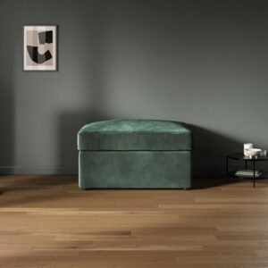 Luxe velvet bottle green footstool sofa bed with a simple design in a modern, minimalistic living space.