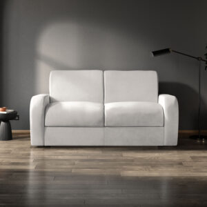 Modern two-seater Deco sofa in a light grey fabric, set against a dark, minimalist interior with a sleek floor lamp and side table.