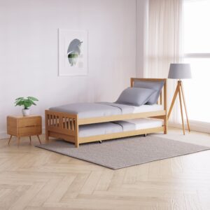 Single natural wood guest bed styled in a bright room with a bedside table, artwork, and soft bedding.