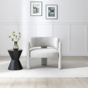 Adelaide accent chair in natural textured weave with three-legged design, styled with a black side table and minimalist modern décor.