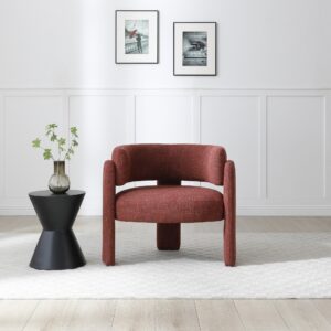 Adelaide accent chair in rust textured weave with three-legged design, styled in a modern living space with a black side table and glass vase.