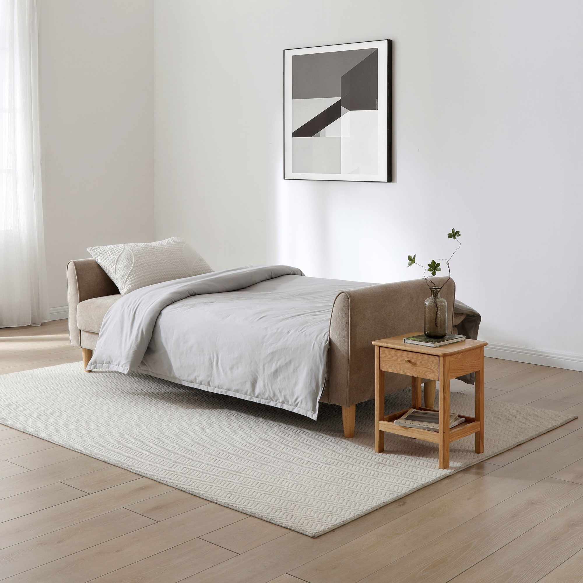 Harvey Sofa Bed in taupe chenille made up as a bed with bedding in a living room