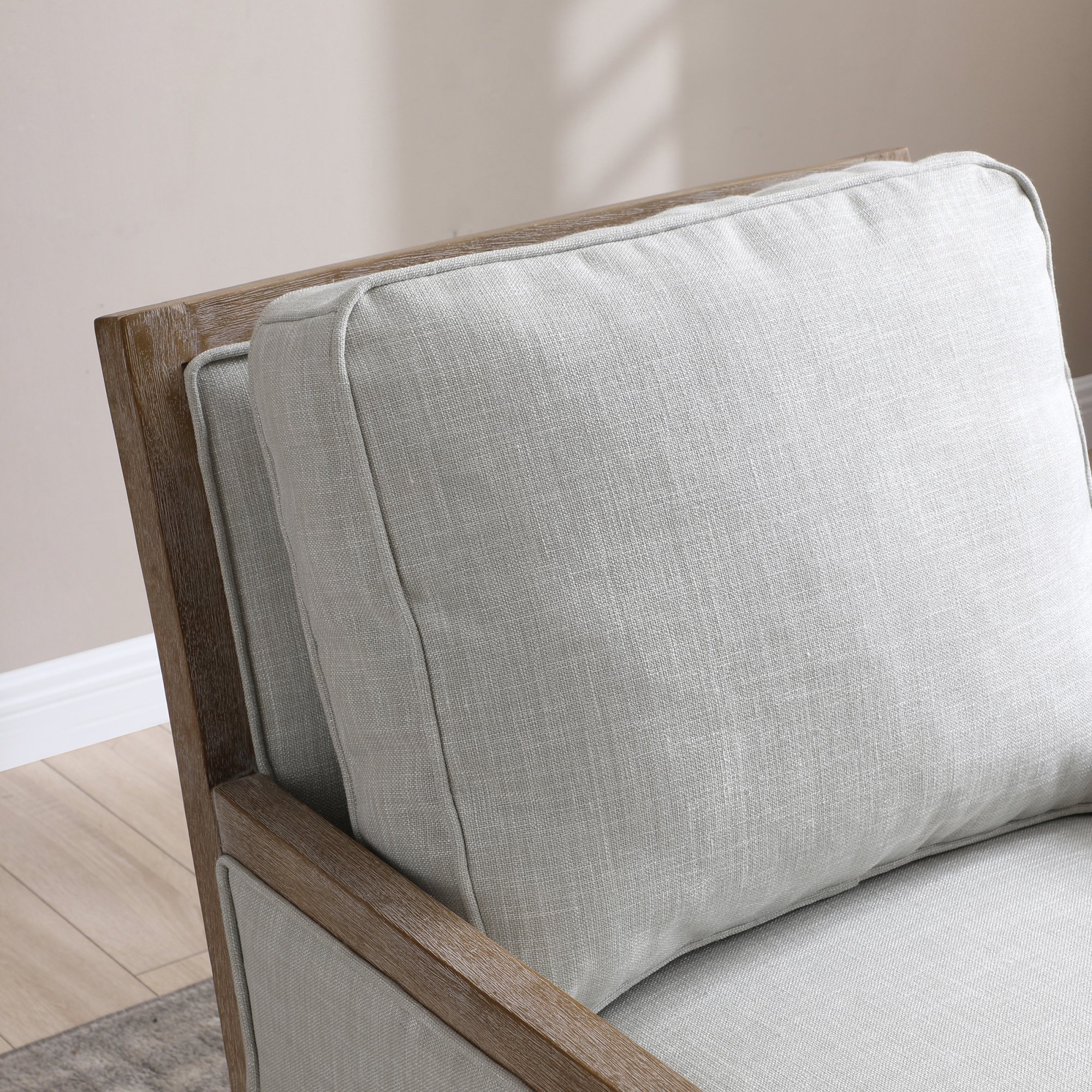 Beatrice Armchair front view showing the piped arm panels