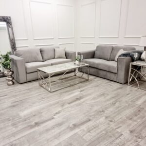 Hudson three and two seater sofa set in a panelled showroom room setting with a glass coffee table