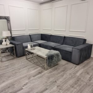 Midland velvet corner sofa in a panelled showroom room setting with a coffee table