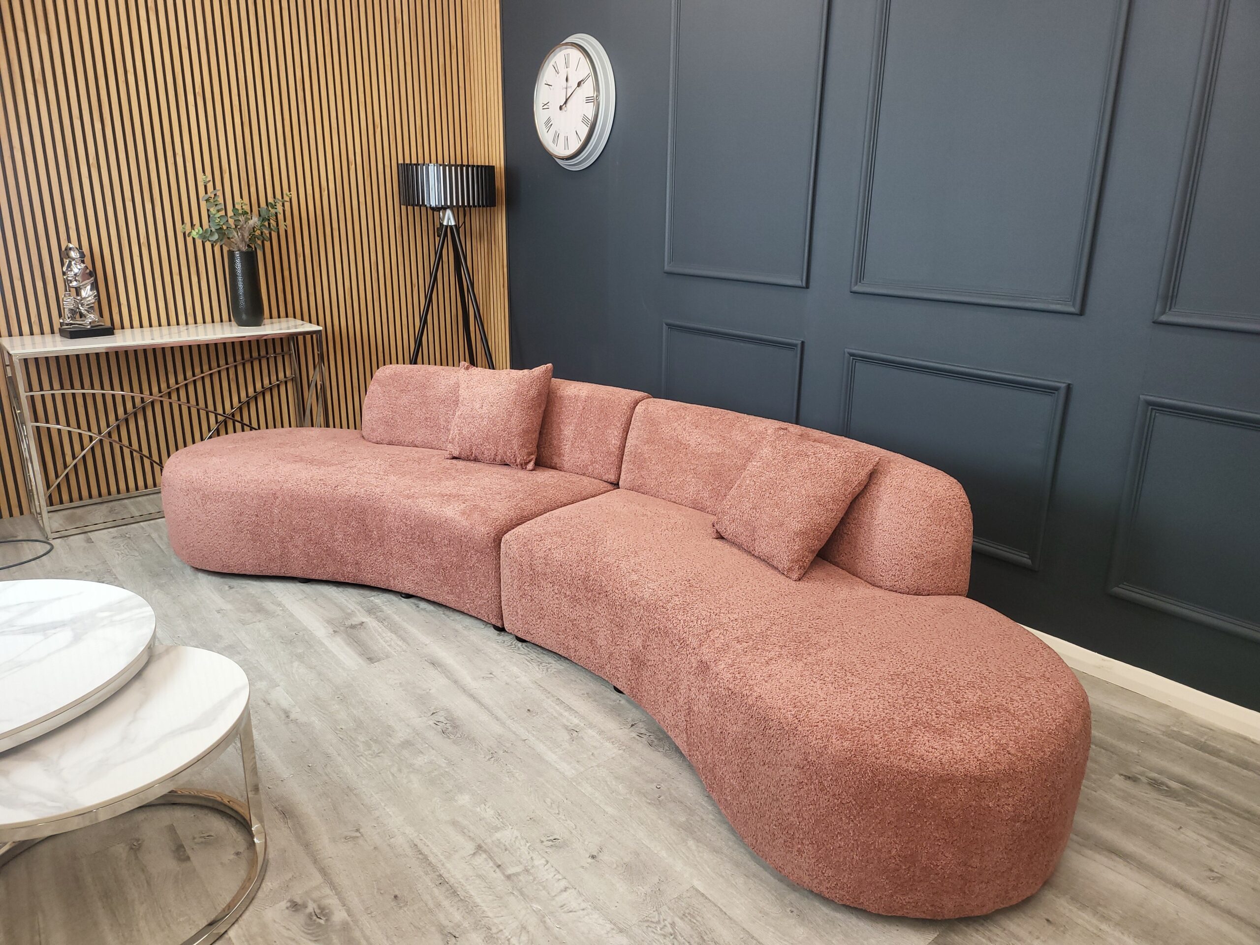 Miami curved boucle cinema sofa in blush shown full length in a styled room