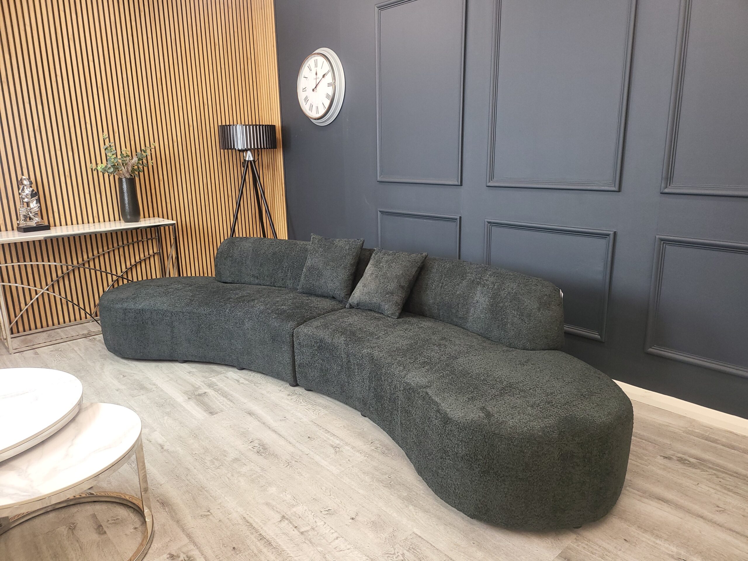 Miami curved boucle cinema sofa in black shown full length in a styled room