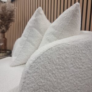 Cuddle accent chair scatter cushions and cream boucle texture in close detail