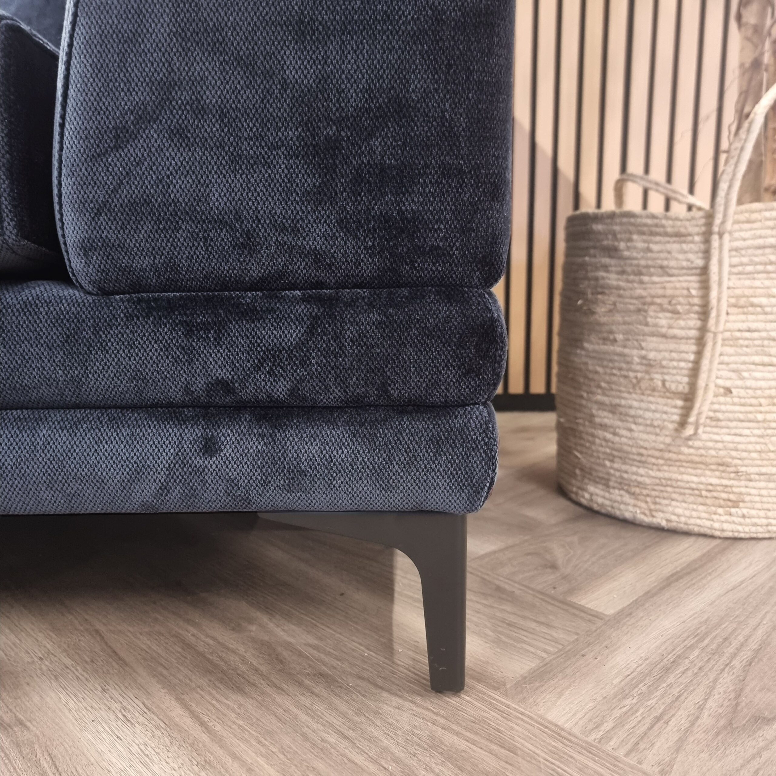 Detail of the Lenox sofa base and dark metal leg
