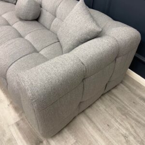 Angled detail of the Aluxo Bubble sofa showing the tufted grey boucle seat and back cushions