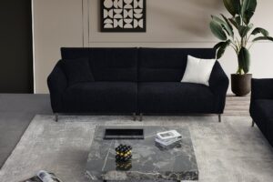 Albany black boucle sofa range in a room setting with rug and plant