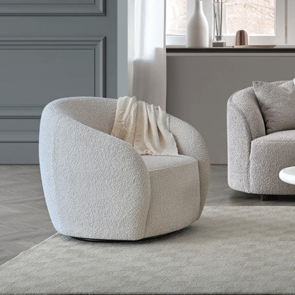 Aluxo Nolita boucle accent chairs styled in a living room beside a window with a rug and side table