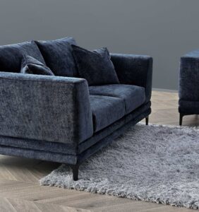 Lenox sofa in aegean blue velvet seen at an angle in a styled room