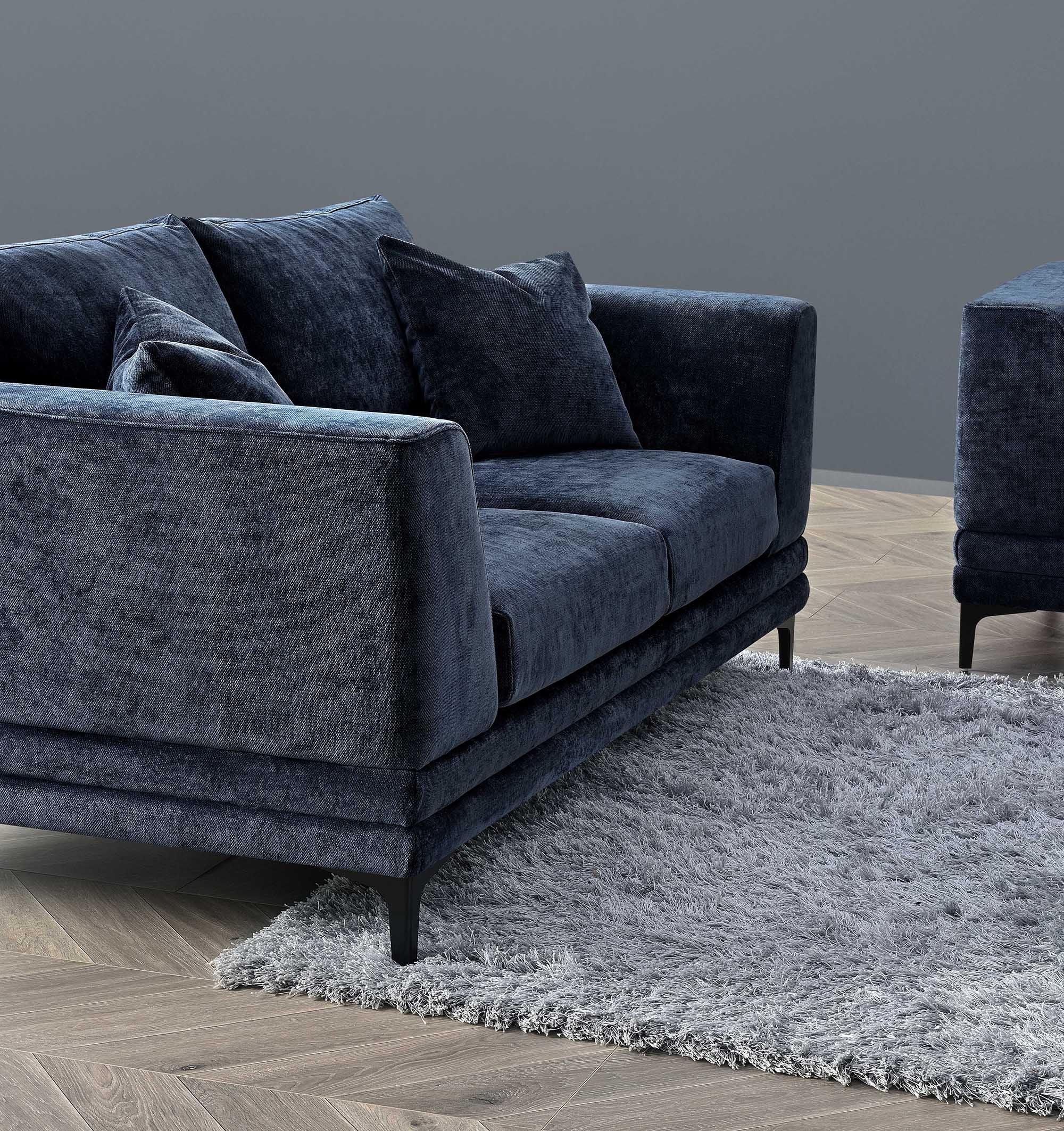 Lenox sofa in aegean blue velvet seen at an angle in a styled room