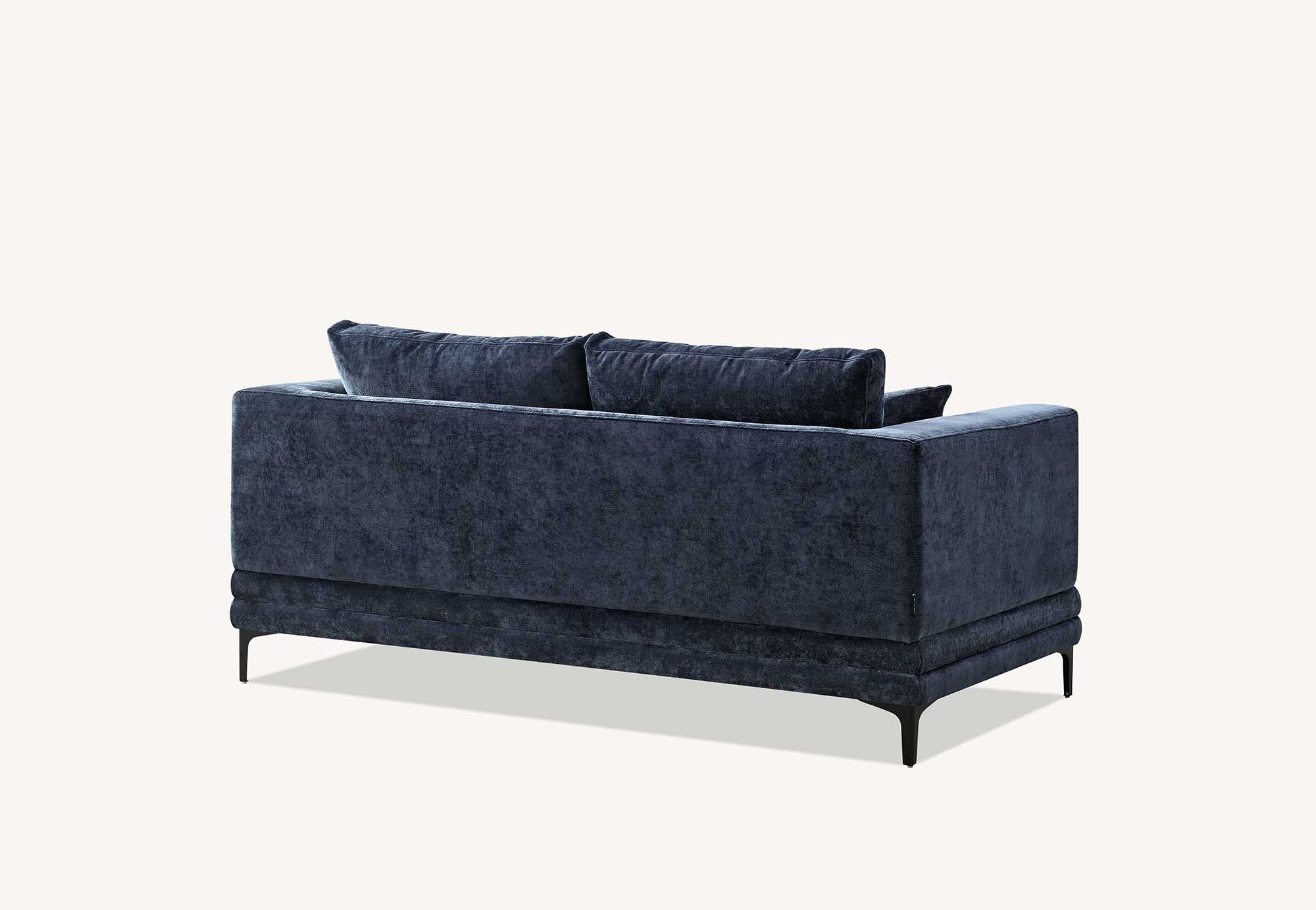 Lenox two seater sofa in aegean blue velvet at an angle showing the slim dark legs