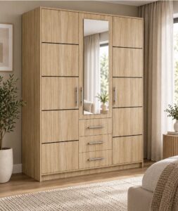 Bali 3 door wardrobe in light Oak Sonoma in a bright bedroom beside a plant