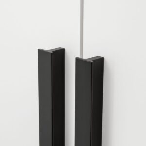Close-up of the long black bar handles on the white Genua wardrobe