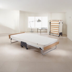 Jay-Be J-Bed single folding bed opened out in a bright room, with the folded bed standing behind