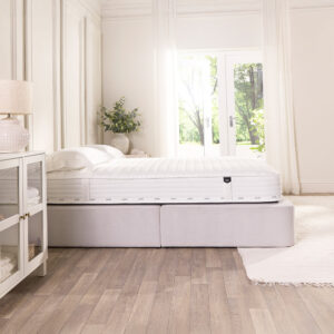 Side view of the 23cm deep Jay-Be Pure Anti-Allergy mattress on an upholstered base