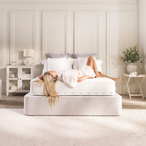 Woman lying back on the Jay-Be Pure Anti-Allergy mattress in a bright bedroom