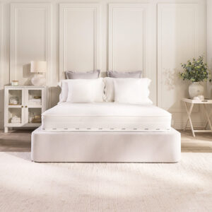Front view of the Jay-Be Pure Anti-Allergy sprung mattress dressed with white pillows on an upholstered bed