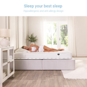 Woman asleep on her side on the hypoallergenic Jay-Be Pure sprung mattress in a sunlit bedroom