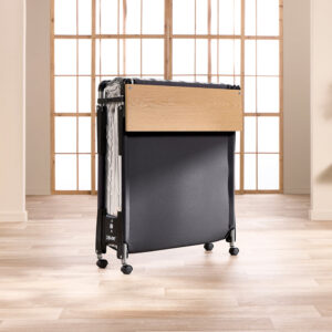 Jay-Be Quick folding bed folded upright on its castors with wooden headboard showing