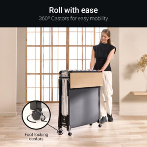 Woman wheeling the folded Jay-Be Quick folding bed on 360 degree foot locking castors