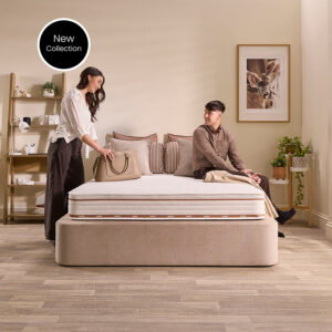 Couple making up a bed with the Jay-Be Ryze 800 pocket sprung mattress on a mink divan
