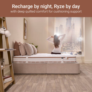 Woman stretching on a Jay-Be Ryze Deep Quilted sprung mattress in a sunny bedroom