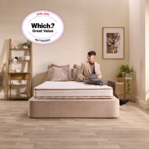 Man sitting on the edge of the Jay-Be Ryze Deep Quilted mattress, showing edge support
