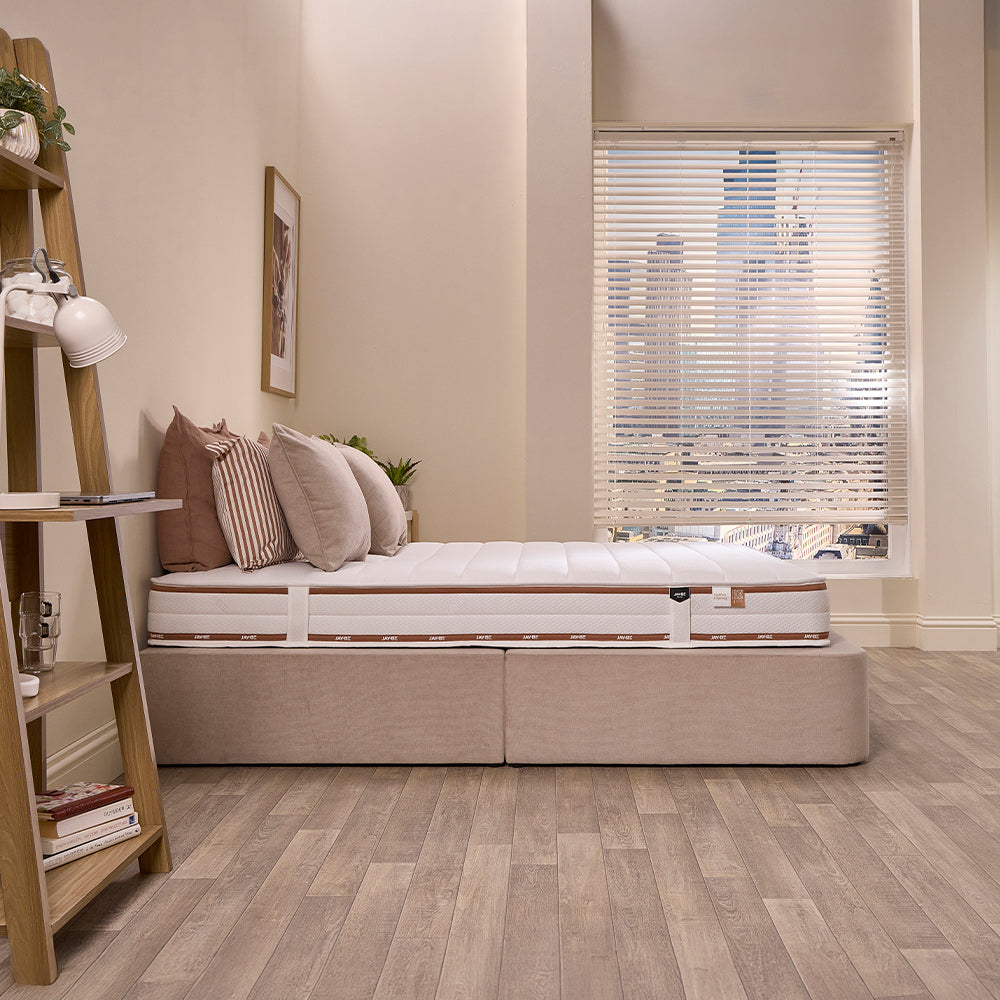 Side view of the Jay-Be Ryze Deep Quilted mattress on a divan base showing its depth and quilted panels