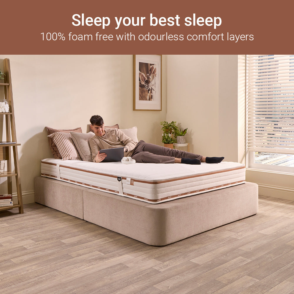 Man resting on a Jay-Be Ryze Memory foam-free sprung mattress in a modern bedroom