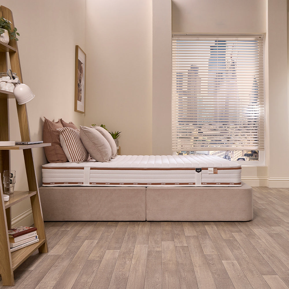 Side view of the Jay-Be Ryze Memory mattress with its copper-trimmed quilted border