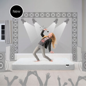 Jay-Be Simply Kids Anti-Allergy Bunk Mattress with a grey border lying on a stage set while a girl sings into a hairbrush