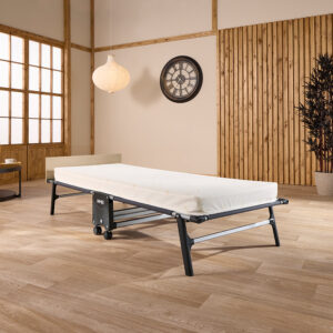 TC80 Tourist folding bed open with its cream Contract mattress on a wooden floor