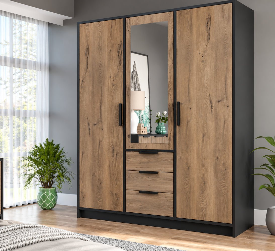 Lati 3 door wardrobe in Oak Viking and black with a mirrored centre door and three drawers in a bedroom